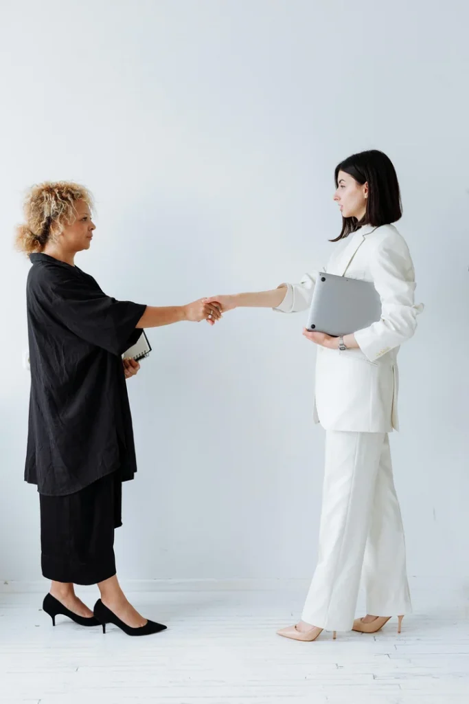 Two women shaking hands